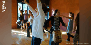 Dohee Lee drumming with dancing participants