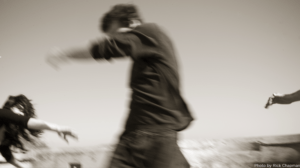 man turning away with woman reaching towards him and another arm reaching out