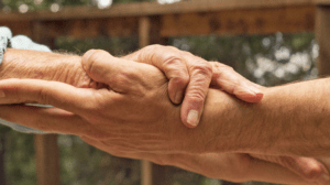 Anna Halprin and grandson holding hands